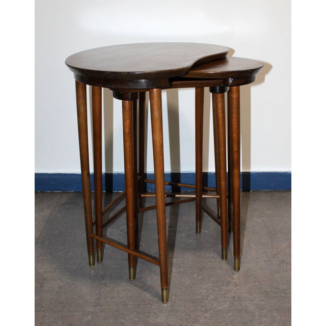 Set of three nesting tables in solid teak, featuring an organic design typical of the Danish Modern style by Edmund...