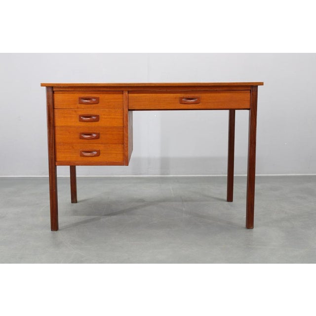 This refined mid-century modern writing desk was produced in Denmark during the 1960s. Constructed from solid teak and...
