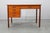 This refined mid-century modern writing desk was produced in Denmark during the 1960s. Constructed from solid teak and...