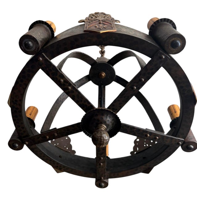 Perfect for over a bar, in a playroom, or space that needs character. Hammered Iron and brass with details of red...