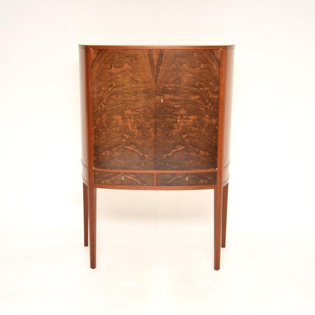 An absolutely stunning and extremely well made vintage Swedish walnut drinks cabinet by Johan Byström. This was recently...