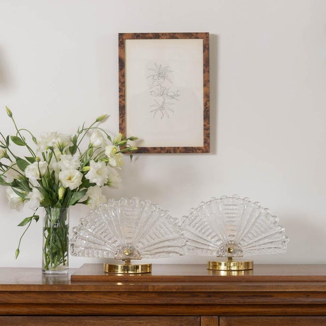 Beautiful pair of Art Deco glass and brass table lamps. Fluted shell demi lune glass shade with ribbed detailing and wavy...