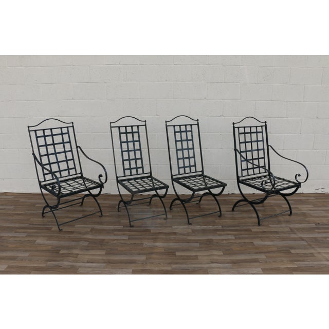 Beautiful vintage set of four French wrought iron folding patio chairs by Hervé Baume, circa 1970s. The set includes two...