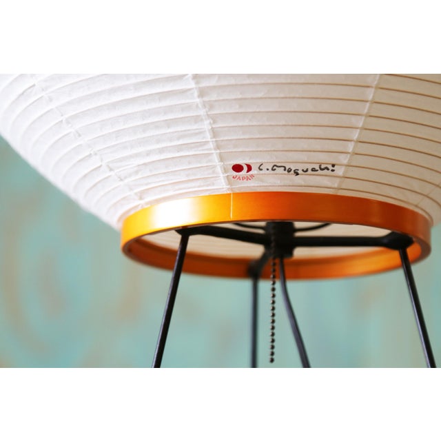 A vintage Akari 9AY table lamp designed by Isamu Noguchi. This is a vintage example from the 1960s. The original shade was...