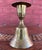 This is a charming vintage brass candlestick featuring a functional bell-shaped base with its original interior clapper....