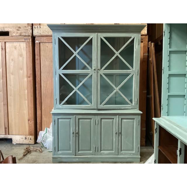 Exceptional pair of custom painted bookcases. Made in France, this pair of bookcases has been painted a shade of green...