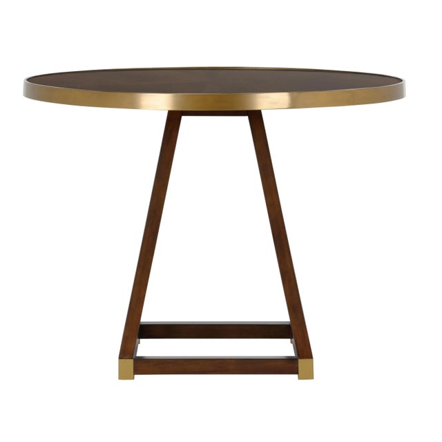 Crafted of wood with antique brass detailing, Renzo Center Table makes a stunning statement in a foyer or breakfast room....