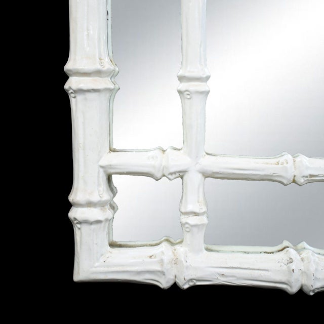A graceful mirror framed in delicate fretwork with a faux-bamboo motif, adding classic Palm Beach charm to any wall. The...