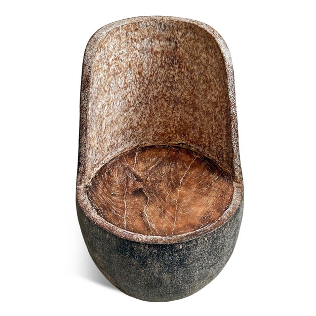 Solid coconut palm hand carved sculptural vintage chair. Celebrating the natural density and dramatic grain of the...