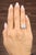 A stunning GIA-Certified 1.10-carat cushion-cut diamond takes center stage, exuding brilliance with its white hue....