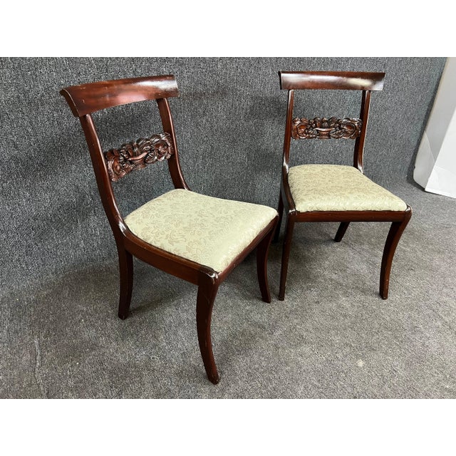 A pair of mahogany side chairs with carved basket details. Seat comes off for upholstery. Made by Potthast Brothers