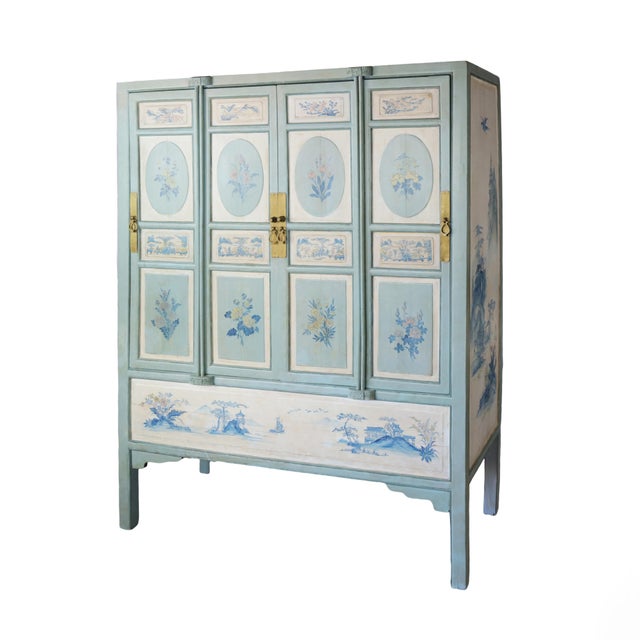 Large Chinese 20th-century cabinet with blue and white hand-painted flowers and landscape panels.The cabinet doors feature...