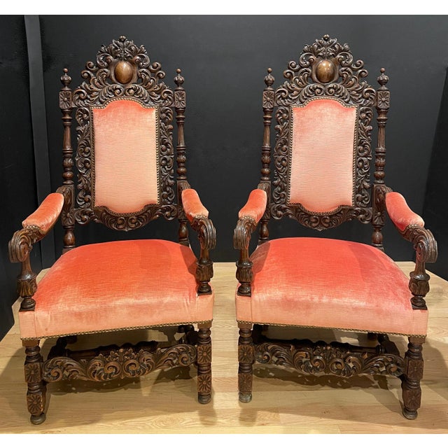 Striking pair of 19th-century French Baroque armchairs, finely carved in dark-stained wood with dramatic, sculptural...