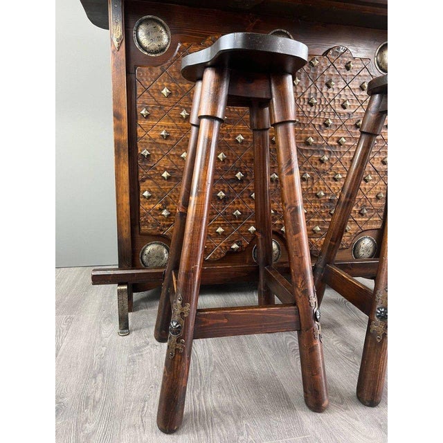 Discover this unique set featuring a solid carved wooden bar, two matching stools, and an elegant wine rack. Ideal for...