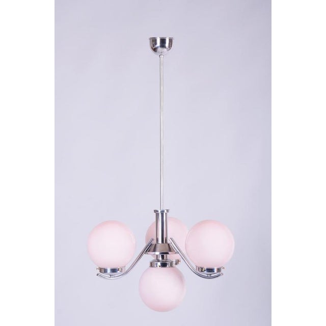 This elegant chandelier dates back to the 1920s and is an excellent example of Czechoslovak design from the Art Deco era....