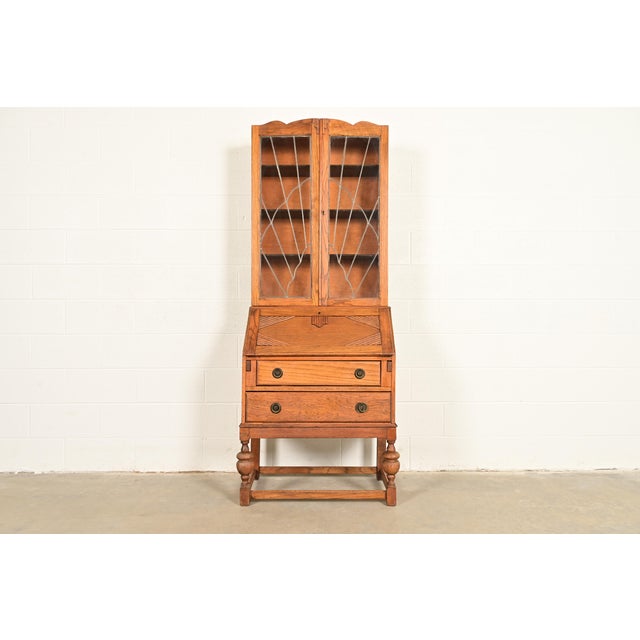 A gorgeous antique English Art Deco bureau with drop front secretary desk and bookcase hutch top England, Circa 1920s...