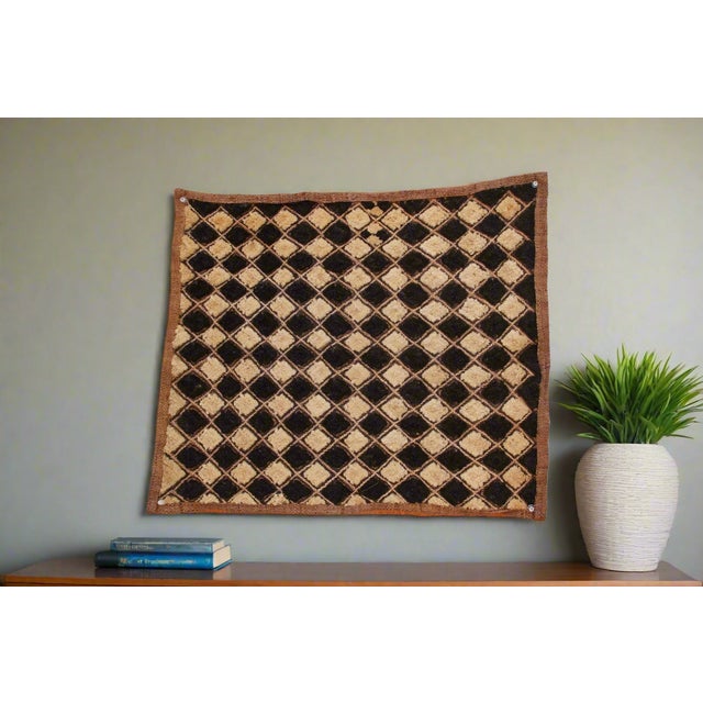 A captivating masterpiece of African textile art, this vintage Kuba cloth panel is a testament to the unparalleled...