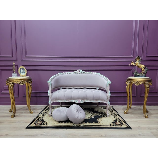 The soft neutral upholstery paired with the delicately painted carved wood frame creates a romantic antique aesthetic,...