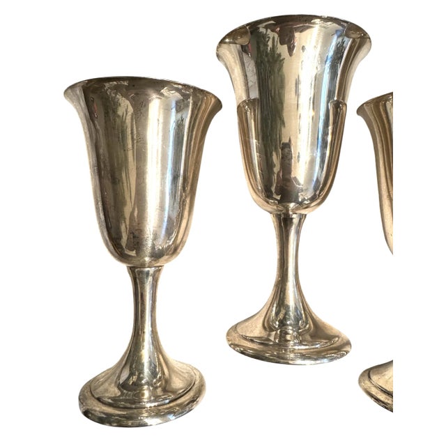 This elegant set of eight sterling silver goblets was crafted by Alvin, a respected American silversmith known for refined...