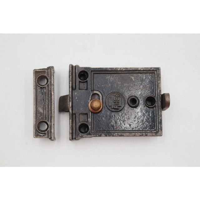 Antique cast iron door rim lock with a brass lock latch. The lock switch is in working order. The original mounting screws...