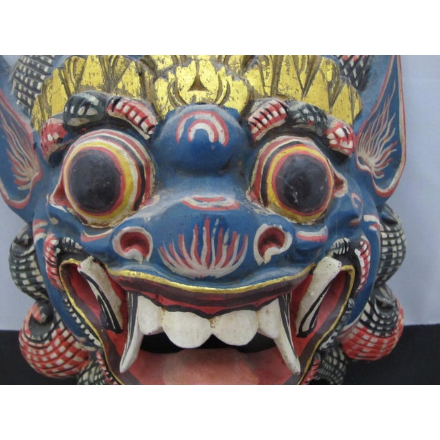 Hand-carved, brightly hand-painted wooden Balinese Barong mask, a protective demon mask from Indonesia. It represents...