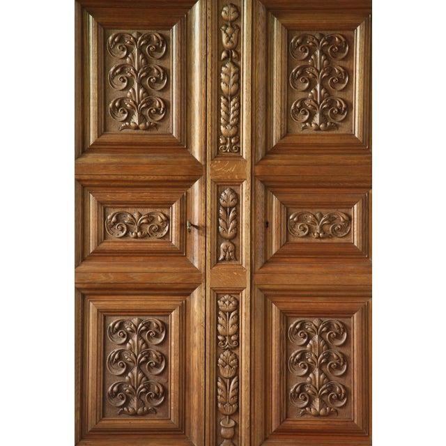 A stunning piece, featuring intricate hand-carved patterns on its front panels in the style of Victorian English oak...