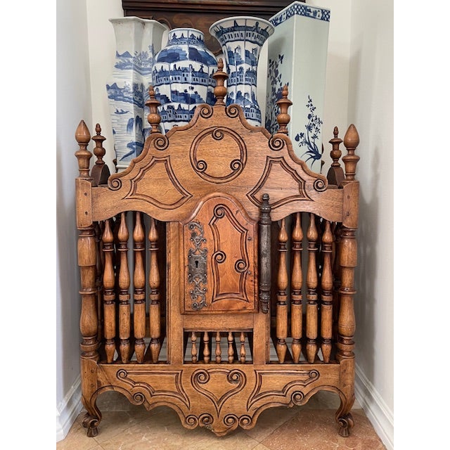 A French provincial carved beechwood panetiere. 19th century. Topped by finials, all intact. A rare and desirable French...