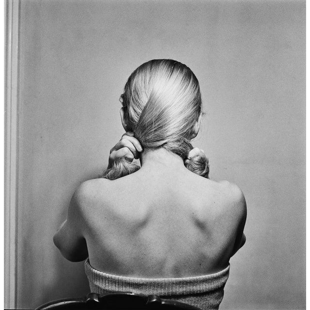 Hair Fashion by Bill Brandt A fashion model demonstrates combing her hair, London, September 1949. Original Publication...