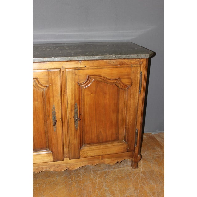 A Louis XV style hunting or stone chest in molded walnut, opening with two doors, original Saint Cyr stone top, four...