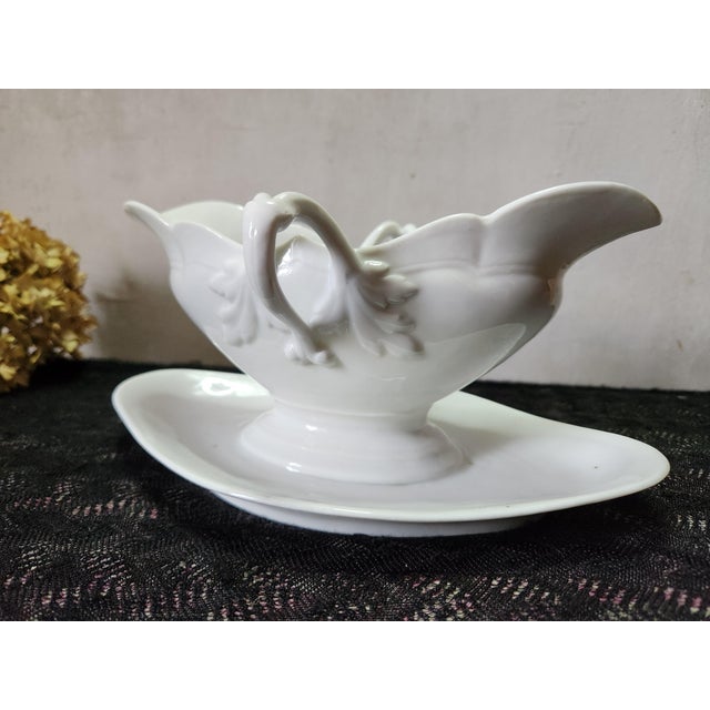 Antique French porcelain Leon Sazerat Limoges sauce boat. It has gorgeous leaf details on the handles. There are some dot...