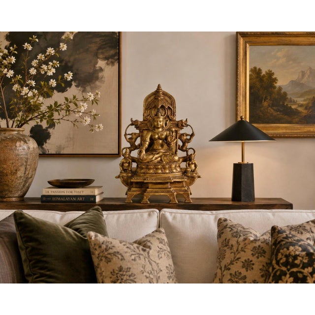 A finely cast Tibetan gilt bronze figure of a Buddhist deity seated in lalitasana (royal ease) on a double-lotus throne...