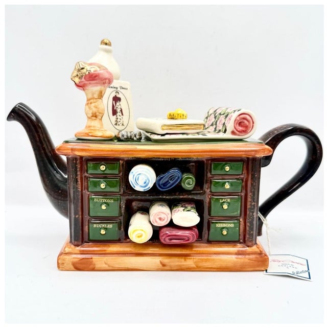 Large Tony Carter novelty teapot modeled as a sewing table, complete with dress form, fabric bolts, scissors, pin cushion,...