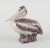 Jeanne Grut for Royal Copenhagen, ceramic pelican figurine. Glaze in brown tones. Model number 22296. Mid-20th century....