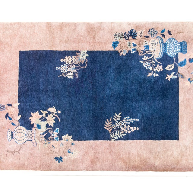 A luminous Chinese Art Deco rug from the 1920s30s, hand-knotted with a striking palette of deep indigo, lavender, and...