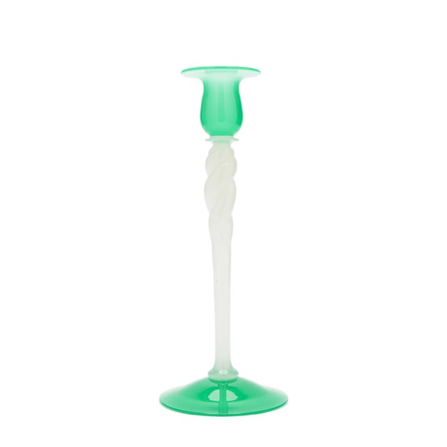 A blown glass candlestick by Steuben, dating to about 1925. A jade green circular foot rises into a white opaline shaft...