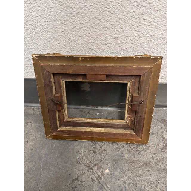 Design Plus Gallery presents a Small Antique Rococo Style Gilt Picture Frame. This ornate frame has a gold-tone gilt...
