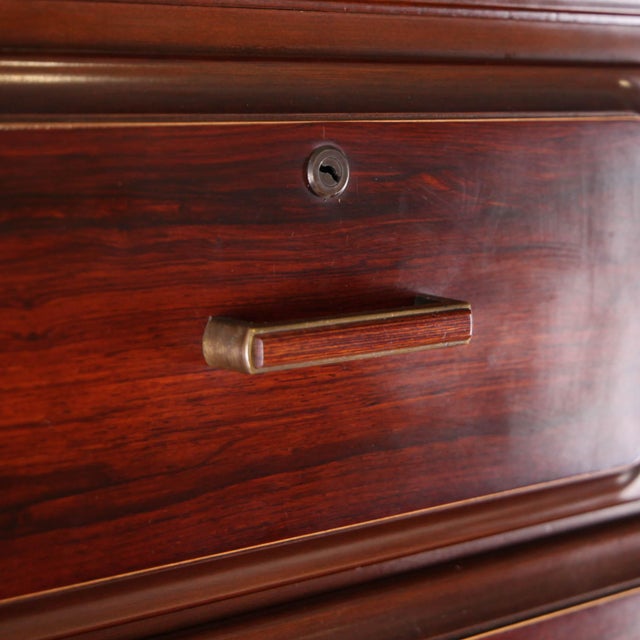 Vintage Japanese tall chest of drawers with 9 drawers. Featuring an exotic wood veneer similar to rosewood and metal...