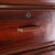 Vintage Japanese tall chest of drawers with 9 drawers. Featuring an exotic wood veneer similar to rosewood and metal...