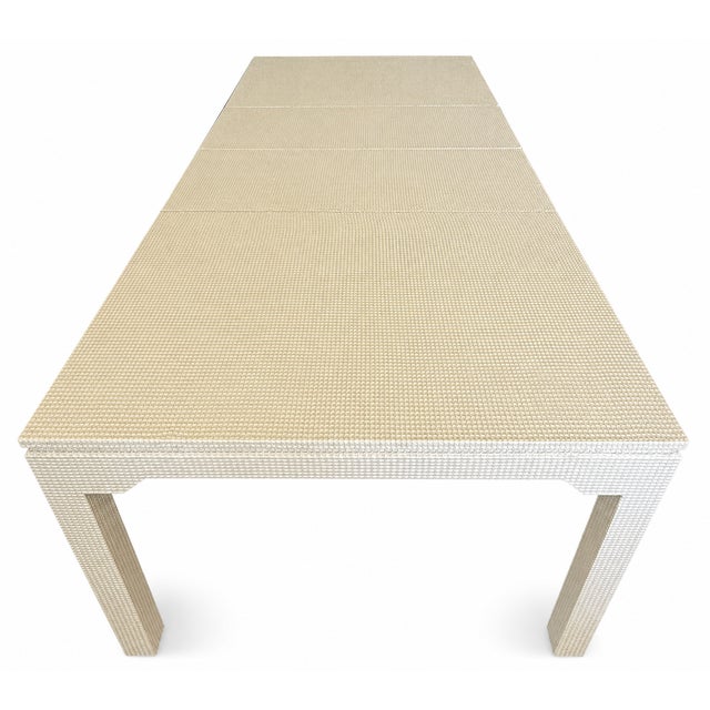This is a Karl Springer-style dining table featuring a cream-colored, textured, grid-patterned grass cloth material. The...