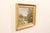 A French landscape painting in frame from the early 20th century. This antique painting from France depicts a tranquil...