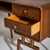 Asymmetrically designed mid-century desk crafted from walnut, featuring four drawers, an open storage compartment, and an...