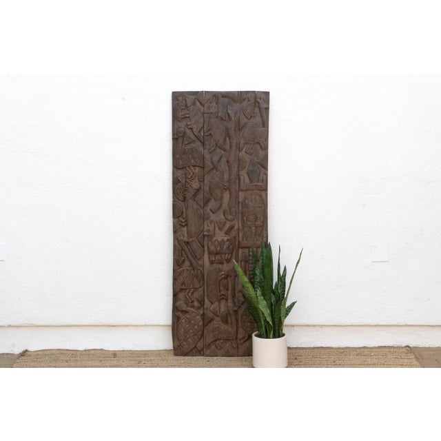 Attributed to the mid 20th century, this 65-inch architectural entrance door is an authentic three-plank masterwork from...