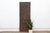 Attributed to the mid 20th century, this 65-inch architectural entrance door is an authentic three-plank masterwork from...