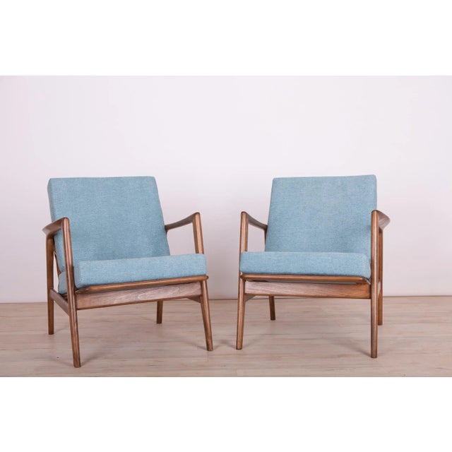 This pair of armchairs was produced by the Polish company Swarzędzka Furniture Factory. The chairs have been reupholstered...