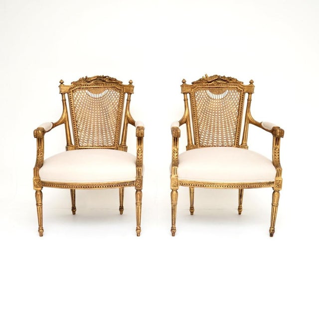 An outstanding pair of antique French gilt wood salon armchairs, dating from around the 1890-1910 period. They are of...