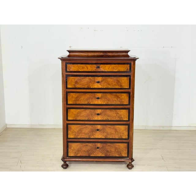 For sale is this beautiful antique chiffonière. The piece of furniture impresses with its elegant walnut veneer and a...