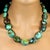 This striking 21-inch necklace features a gently graduated strand of natural turquoise matrix oval nuggets, polished to a...