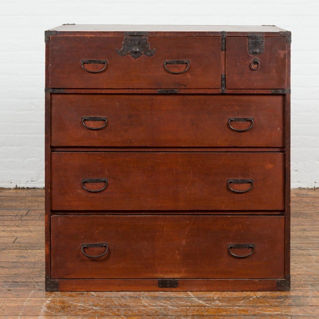 A Japanese Taisho period antique tansu chest from the early 20th century with five drawers and iron hardware. Created in...