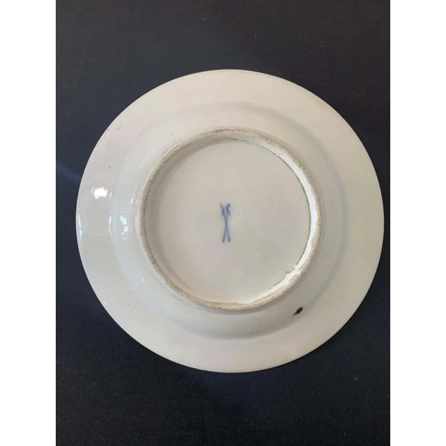 Beautiful little white porcelain plate decorated with different flowers such as petunias and phlox. The leaves seem to...