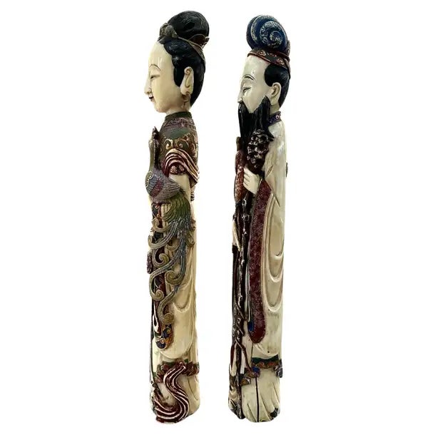 Impressive pair of large Chinese Carved and Polychromed Figurines that depict an elegant male and female in refined...